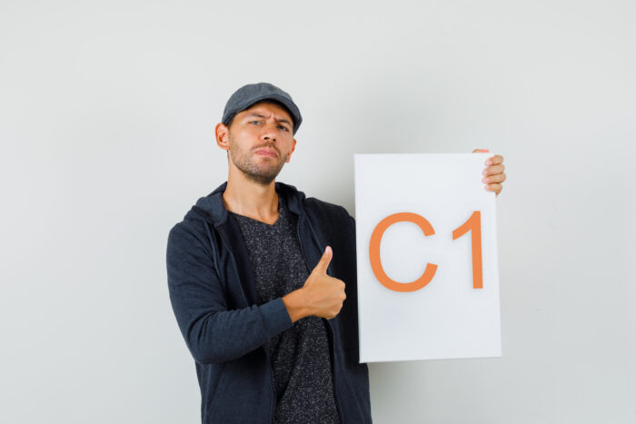 young male holding blank canvas, showing thumb up in t shirt, ja